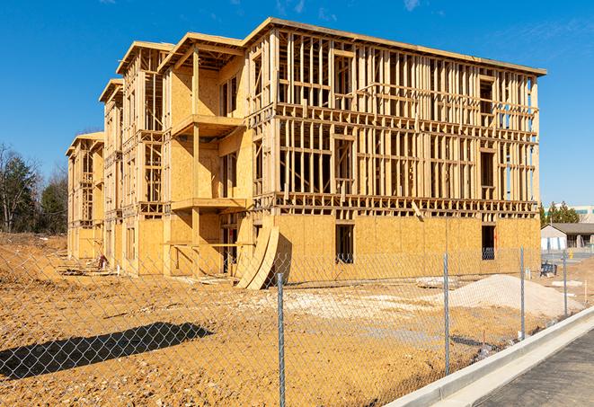 a temporary chain link fence in front of a building under construction, ensuring public safety in Cummings, KS